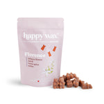 Pink pouch of happy wax brand Florence wax melts with scattered terracotta-colored wax pieces displayed in front.