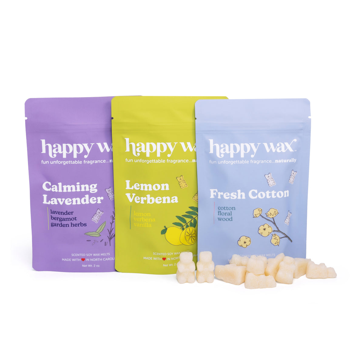 Three Happy Wax pouches in purple, yellow, and blue with wax melts in front labeled Calming Lavender, Lemon Verbena, and Fres