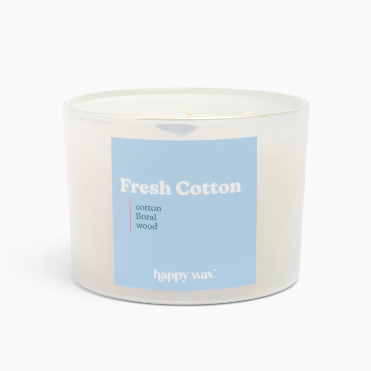 White cylindrical candle with blue label reading "Fresh Cotton" and scent notes, containing three wicks.