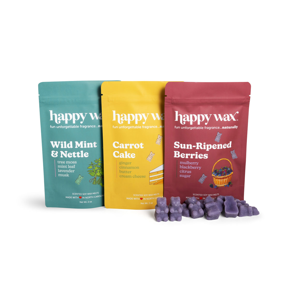 Three Happy Wax scented soy wax melts in teal, yellow, and burgundy pouches with purple wax melts displayed in front.