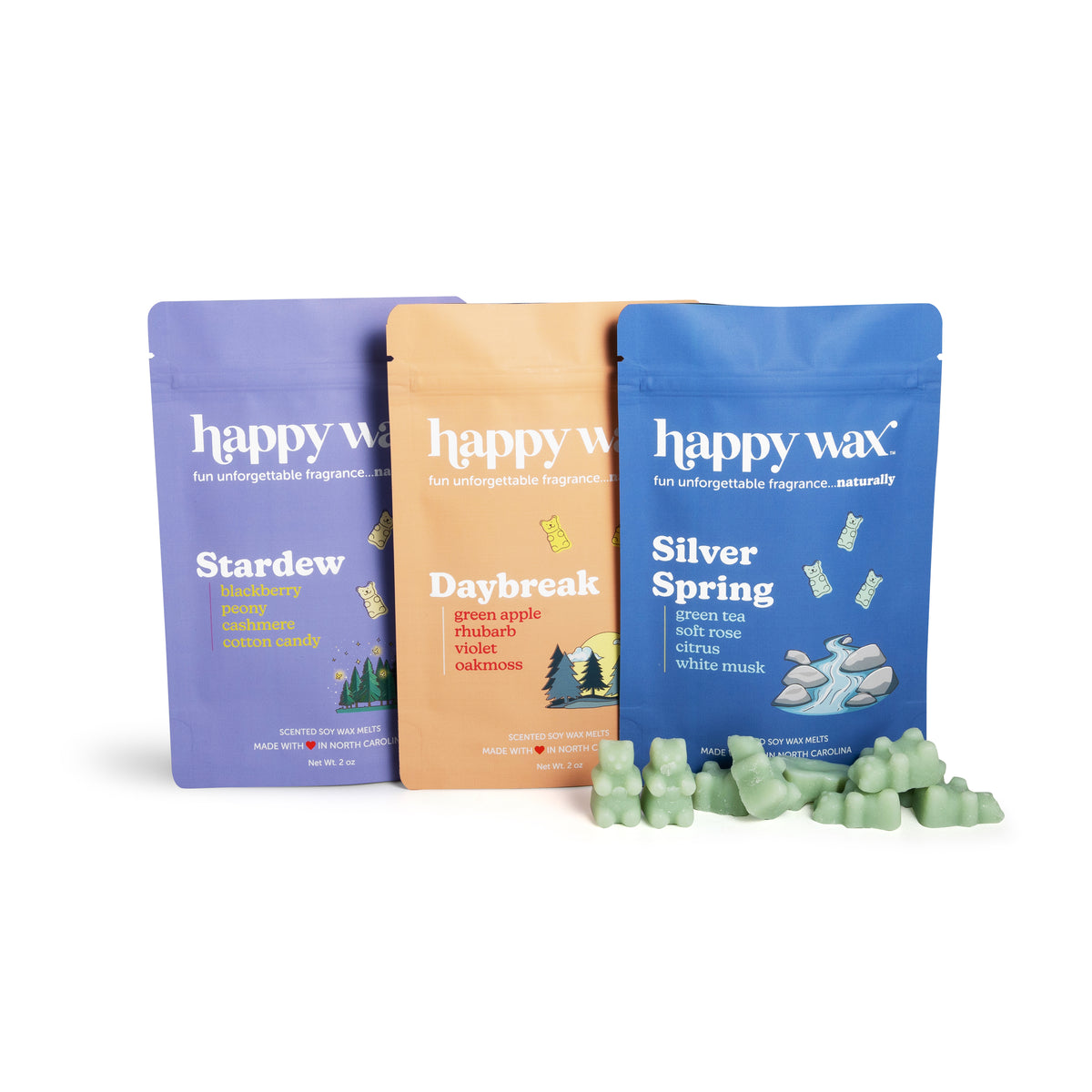 Three Happy Wax pouches in purple, tan, and blue with scent names and green wax melts displayed in front.