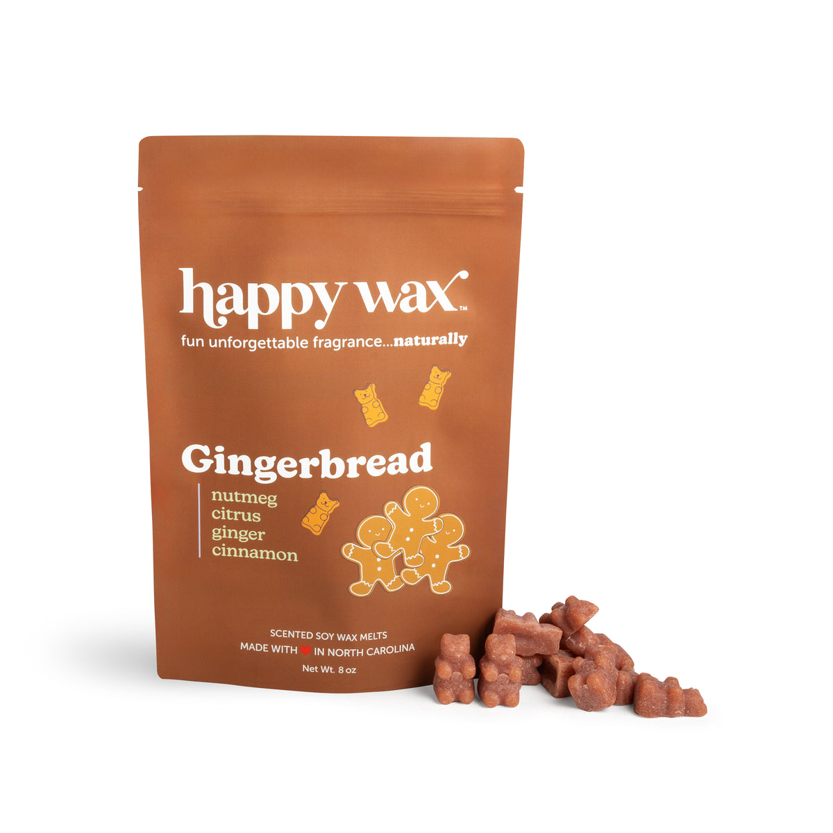 Brown pouch of happy wax gingerbread wax melts with scattered brown wax pieces beside it.