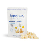 White pouch of Happy Wax Golden Citrus scented soy wax melts with citrus and pet illustrations, displayed with cream-colored 