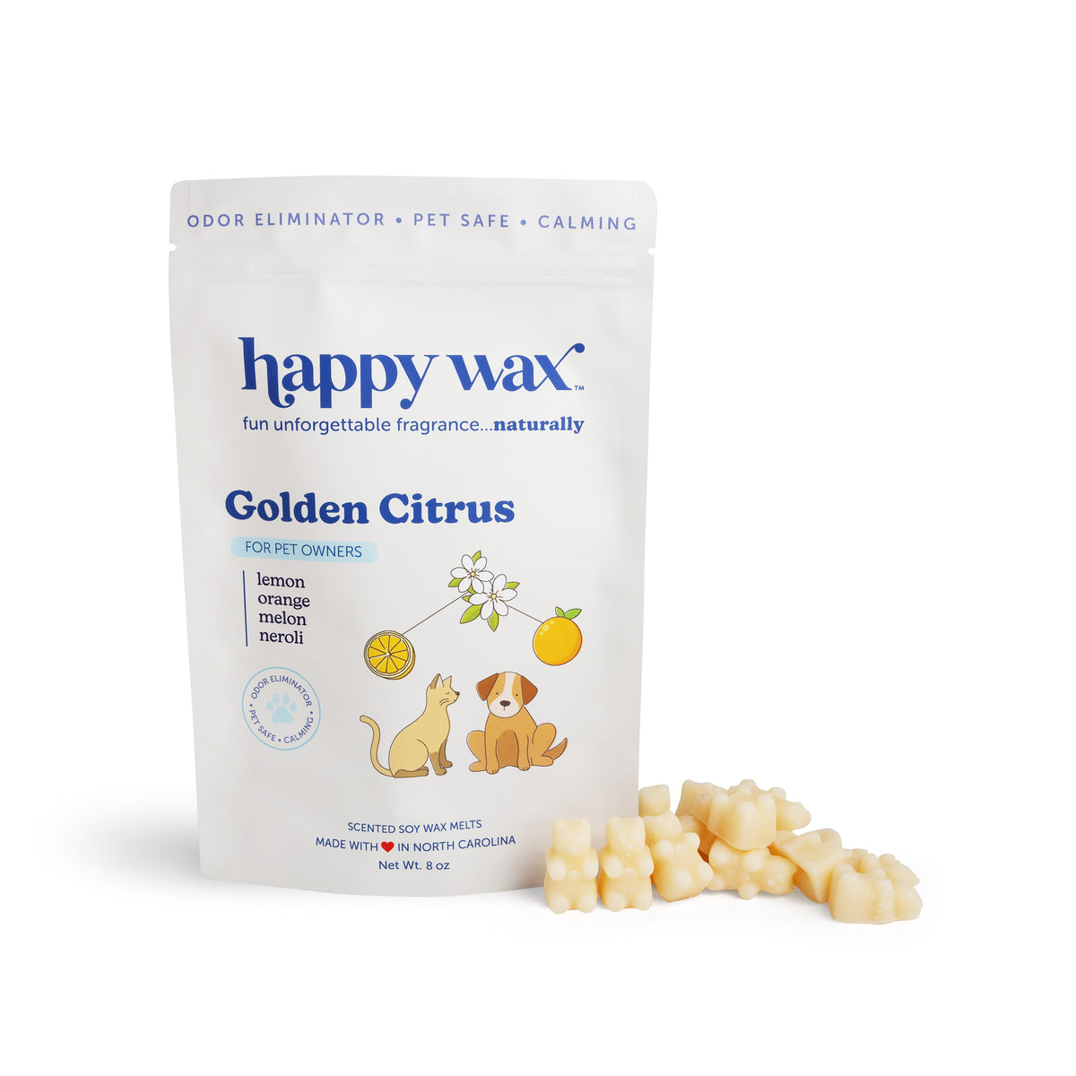 Cream-colored wax melts scattered beside Happy Wax Golden Citrus pouch featuring citrus illustrations and cat and dog graphic
