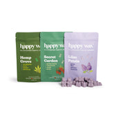 Three Happy Wax scent packets in Hemp Grove, Secret Garden, and Lilac Petals with purple wax melts displayed in front.