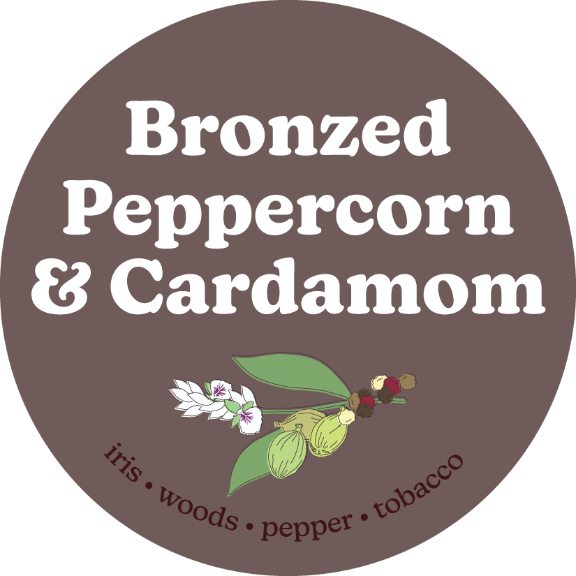 Circular brown label with white text reading "Bronzed Peppercorn & Cardamom" and botanical illustrations of cardamom pods and