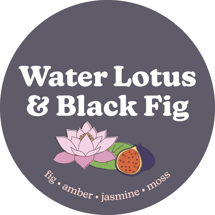 Round gray label with white text reading "Water Lotus & Black Fig" and illustrations of a pink lotus flower and orange fig wi