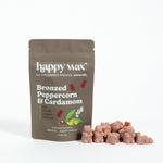Brown pouch of Happy Wax soy wax melts in Bronzed Peppercorn & Cardamom scent with individual wax cubes displayed beside it.