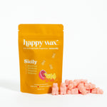 Golden orange pouch of Happy Wax Sicily scented soy wax melts with pink wax cubes displayed beside it.