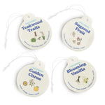 Four cream-colored round car charms with string attachments labeled Teakwood Trails, Sugared Fruit, Golden Citrus, and Bloomi