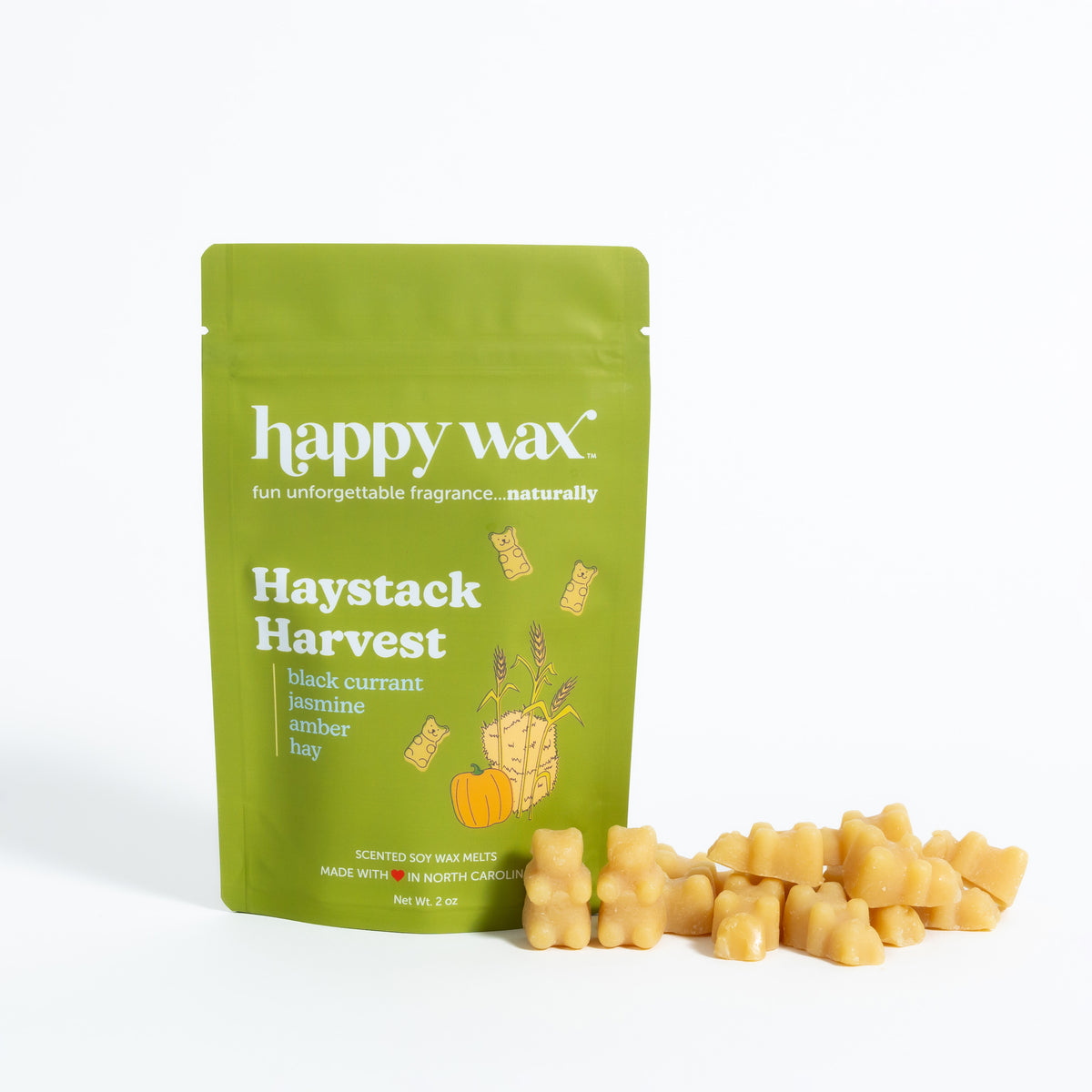 Green pouch of Happy Wax Haystack Harvest soy wax melts with cream-colored wax pieces displayed in front.