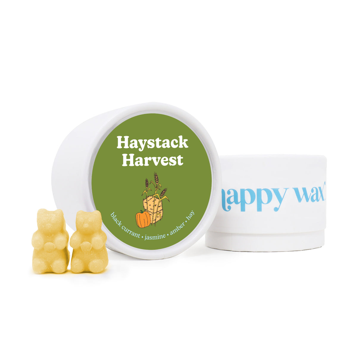 Pale yellow wax melts shaped like bears next to a white container with green label and white jar with blue text.