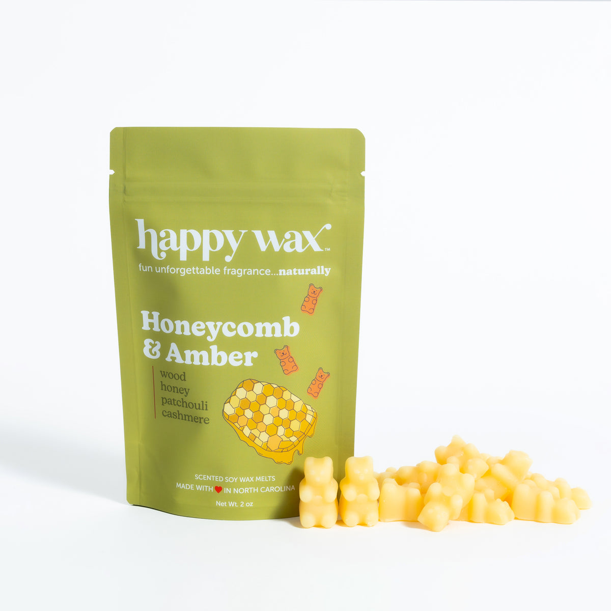 Lime green pouch of Happy Wax brand Honeycomb & Amber soy wax melts with yellow honeycomb-shaped wax pieces displayed in fron