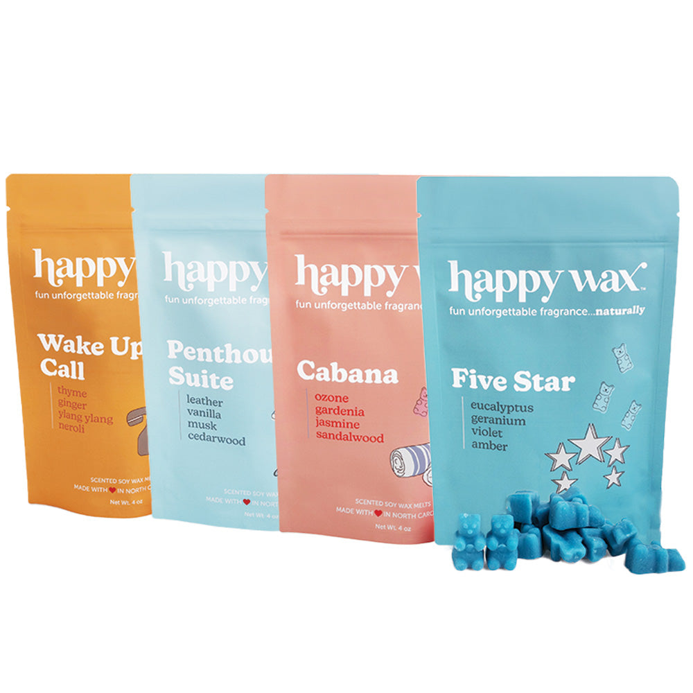Four Happy Wax scented soy wax melts in orange, light blue, pink, and blue pouches with blue wax cubes displayed in front.