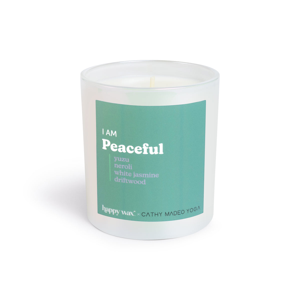 White cylindrical candle with teal label reading "I AM Peaceful" and ingredient list, single lit wick visible.