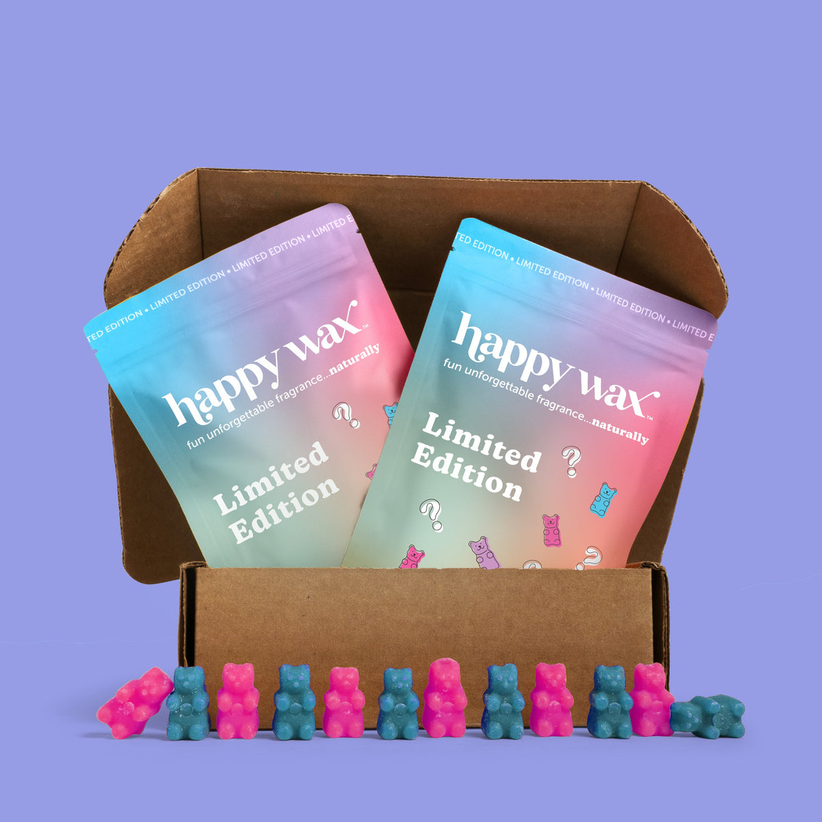 Brown cardboard box containing two gradient-colored Happy Wax Limited Edition packages with colorful wax melts arranged in fr