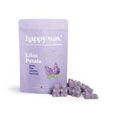 Lavender wax melts in purple chunks next to Happy Wax brand packaging labeled Lilac Petals.