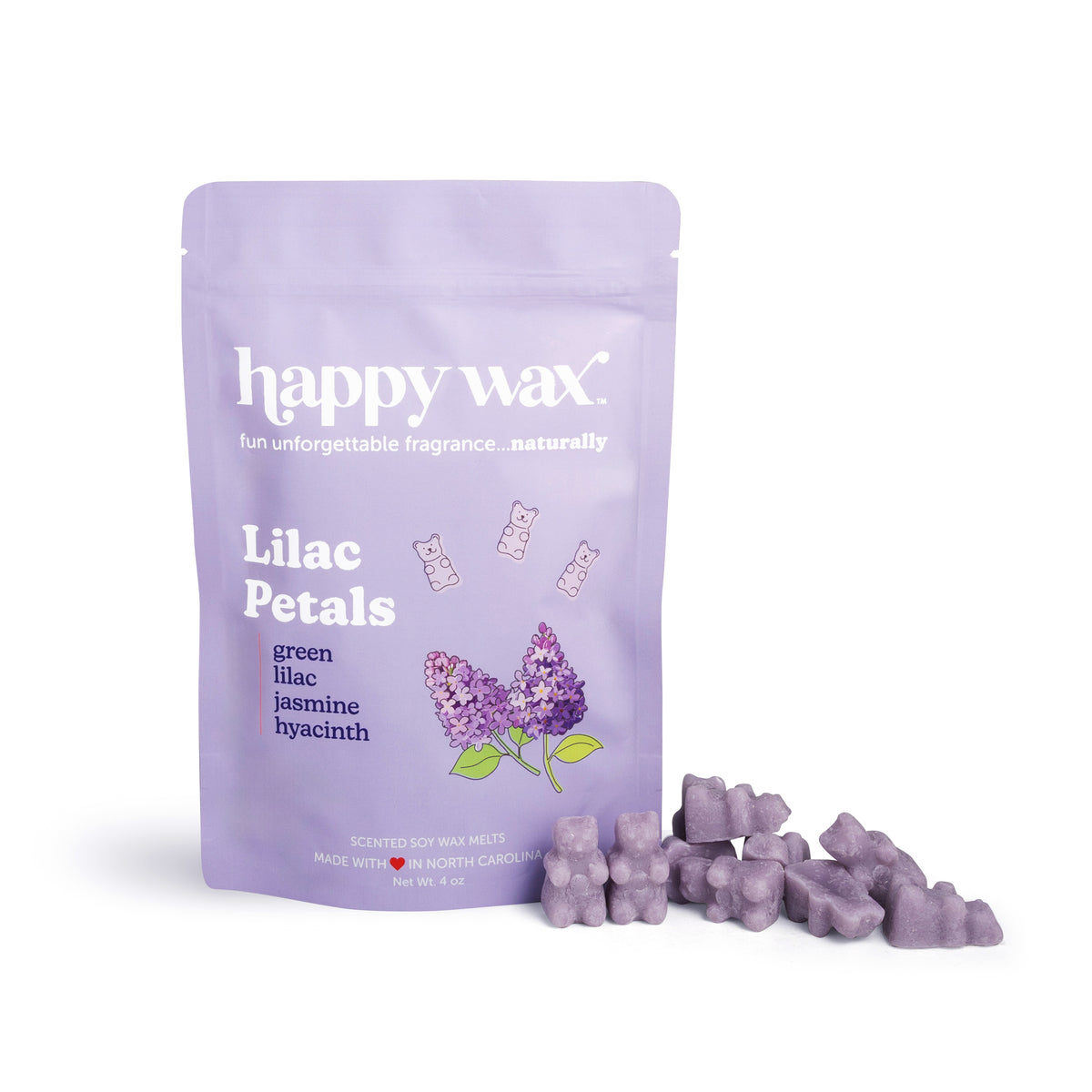 Purple wax melts scattered next to a lilac-colored pouch labeled "happy wax Lilac Petals" with floral illustration.