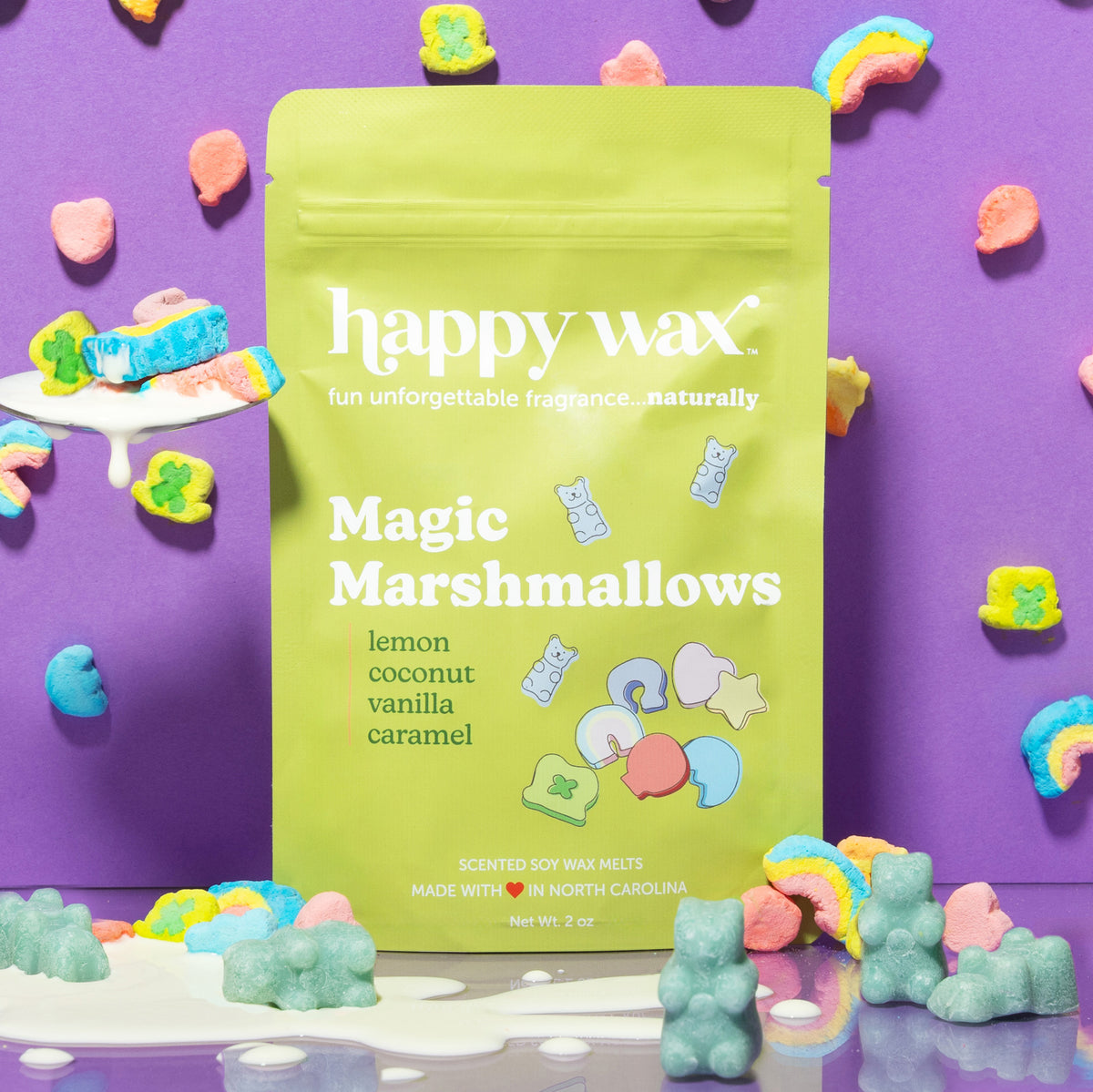 Lime green wax melt pouch labeled "Magic Marshmallows" surrounded by colorful marshmallow-shaped wax melts on purple backgrou
