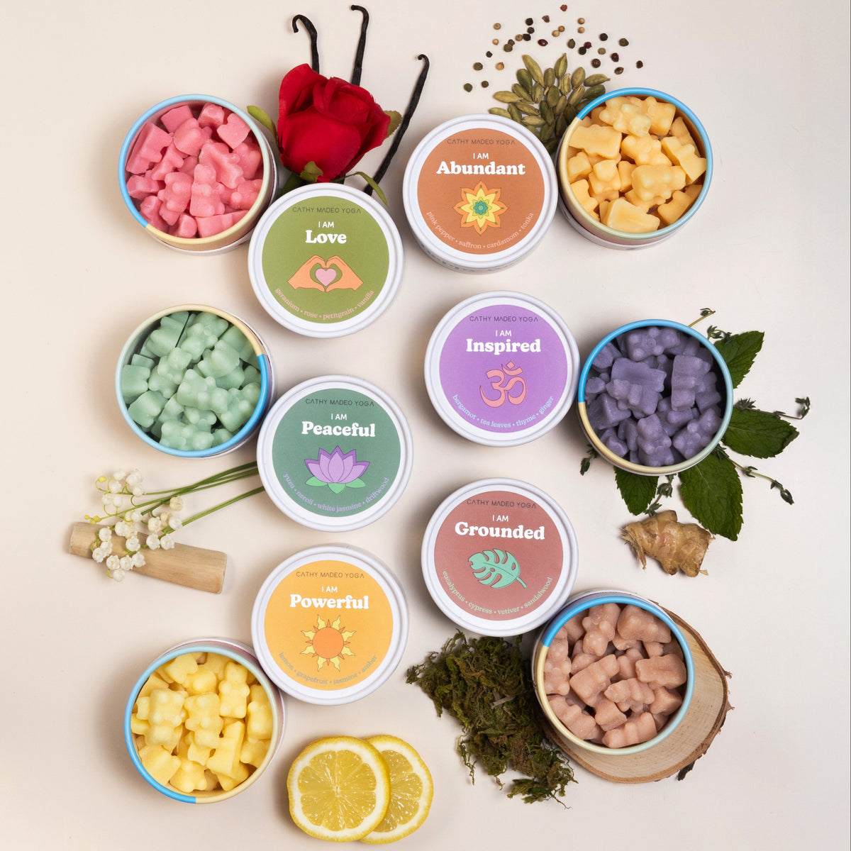Six scented wax melts in labeled containers with affirmation themes: Love, Abundant, Inspired, Peaceful, Grounded, and Powerf