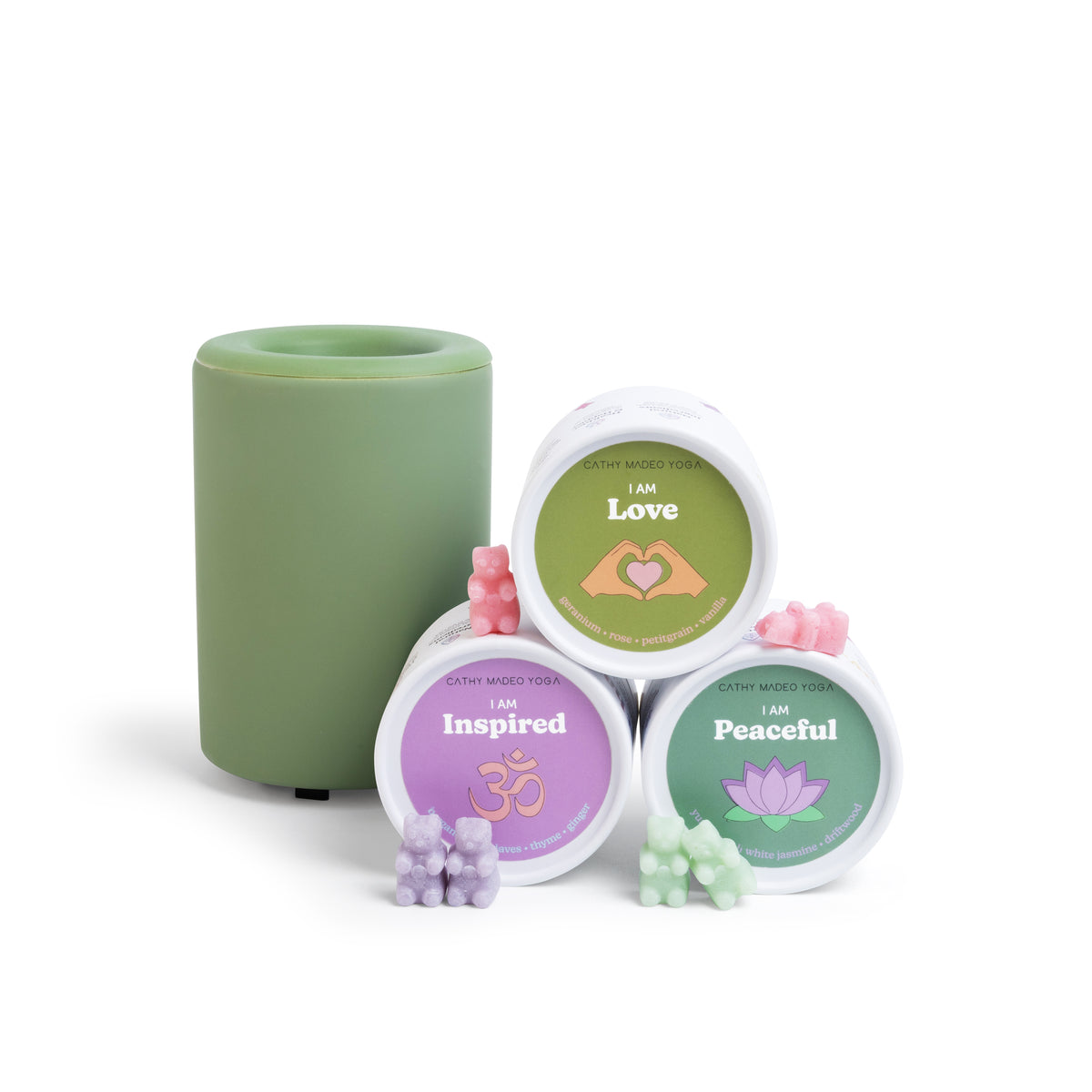 Green cylindrical container with three labeled jars containing wax melts in pink, purple, and green, each with corresponding 