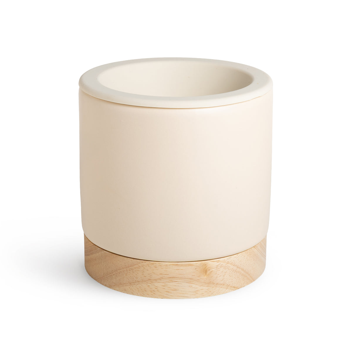Cream ceramic wax warmer with natural wood base and open top bowl.