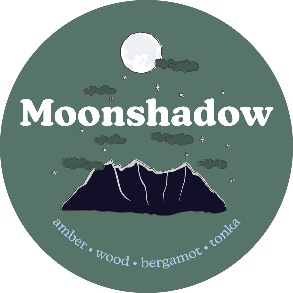 Circular label with "Moonshadow" text, moon, clouds, mountains, and scent notes: amber, wood, bergamot, tonka.
