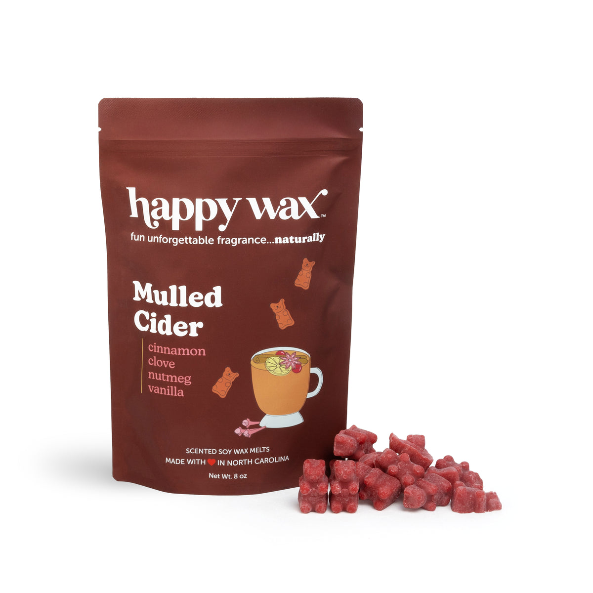 Red wax melts scattered next to burgundy pouch labeled "happy wax Mulled Cider" with ingredient list and mug illustration.