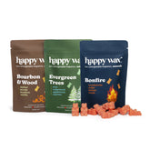 Three Happy Wax scented soy wax packets in brown, green, and navy with coral wax melts displayed in front.