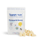 White pouch of Happy Wax Oatmeal & Honey wax melts with cream-colored wax pieces displayed in front.