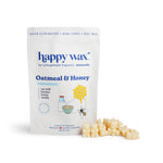 White pouch of Happy Wax oatmeal and honey scented soy wax melts with cream-colored wax cubes displayed in front.