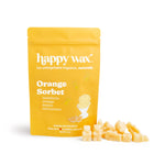 Yellow pouch of Orange Sorbet scented soy wax melts with cream-colored wax pieces displayed beside it.