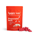 Red pouch of Happy Wax peppermint bark scented wax melts with pink wax cubes displayed beside it.