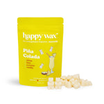 Yellow Piña Colada wax melt package with cream-colored wax melts scattered in front.