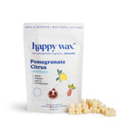 White pouch of Happy Wax pomegranate citrus scented soy wax melts with cream-colored wax pieces displayed beside it.