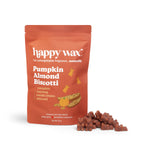 Orange pouch of pumpkin almond biscotti wax melts with brown wax chunks displayed in front.