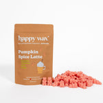 Tan pouch of Happy Wax Pumpkin Spice Latte scented soy wax melts with coral-colored wax cubes displayed beside it.