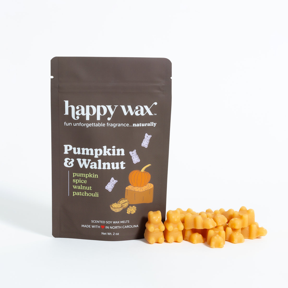 Brown pouch of Happy Wax pumpkin and walnut scented soy wax melts with orange wax cubes displayed beside it.