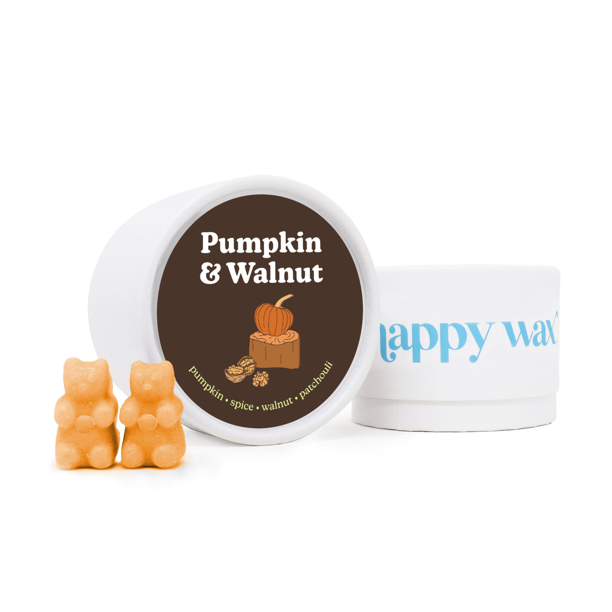 Orange wax melts shaped like bears next to a white container labeled "Pumpkin & Walnut" with a brown lid.