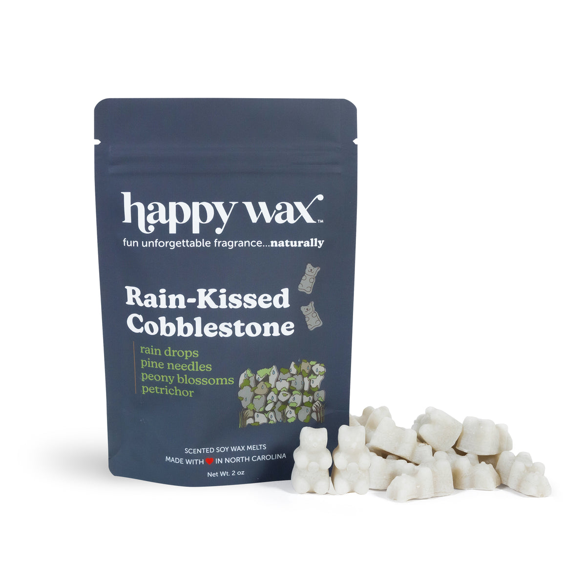 Dark blue pouch labeled "happy wax" with white wax melts scattered beside it.
