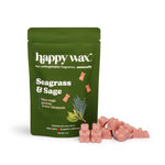 Green pouch of Happy Wax brand seagrass and sage wax melts with pink wax pieces displayed in front.