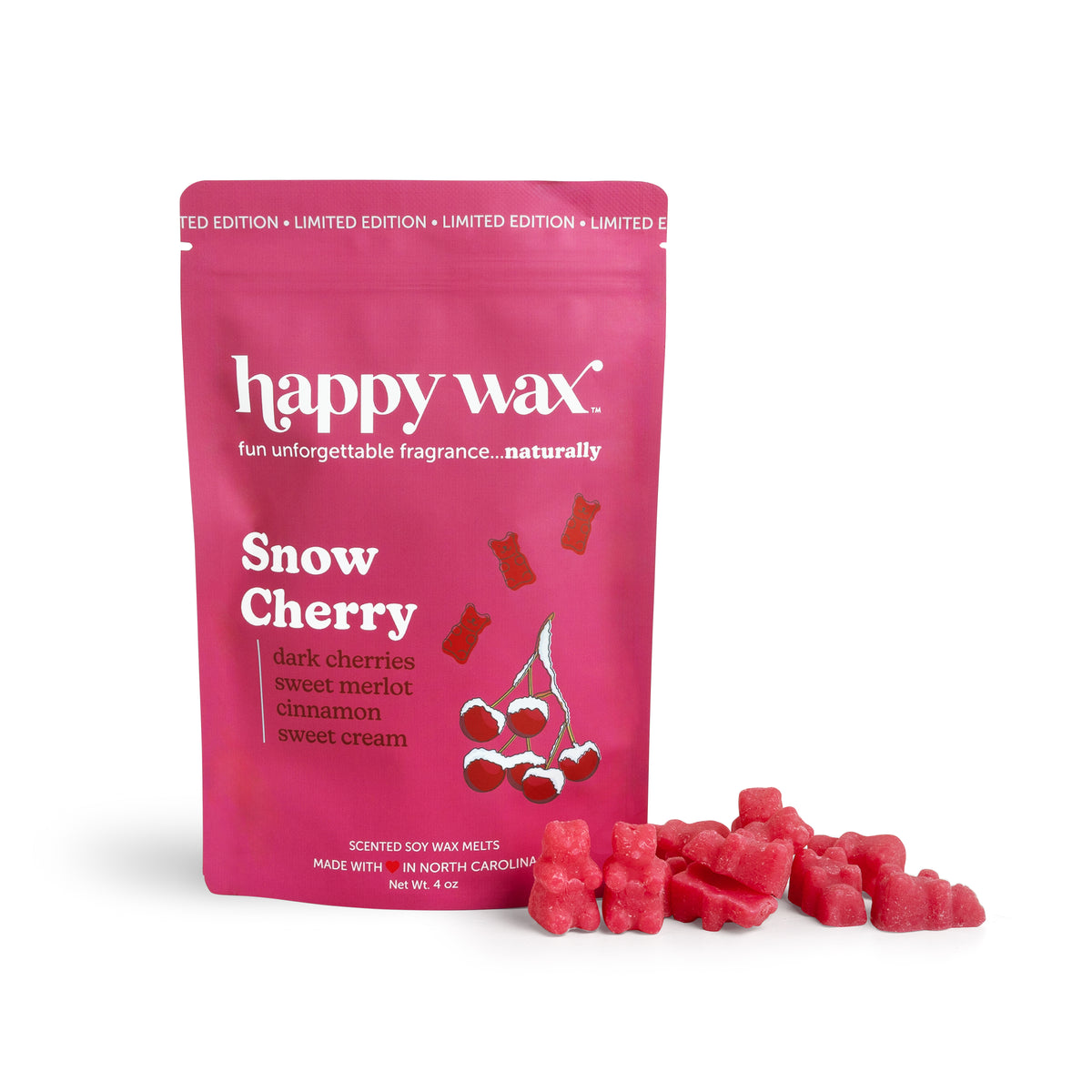 Pink pouch of Happy Wax Snow Cherry soy wax melts with red wax pieces displayed beside it.