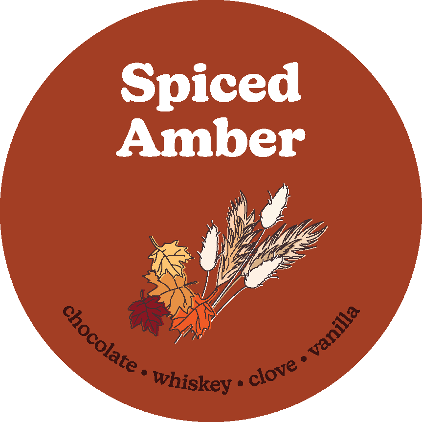 Rust-colored circular label with "Spiced Amber" text and illustrated autumn leaves and wheat, listing chocolate, whiskey, clo
