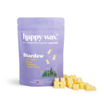 Purple pouch of Happy Wax Stardew wax melts with yellow wax pieces displayed beside it.