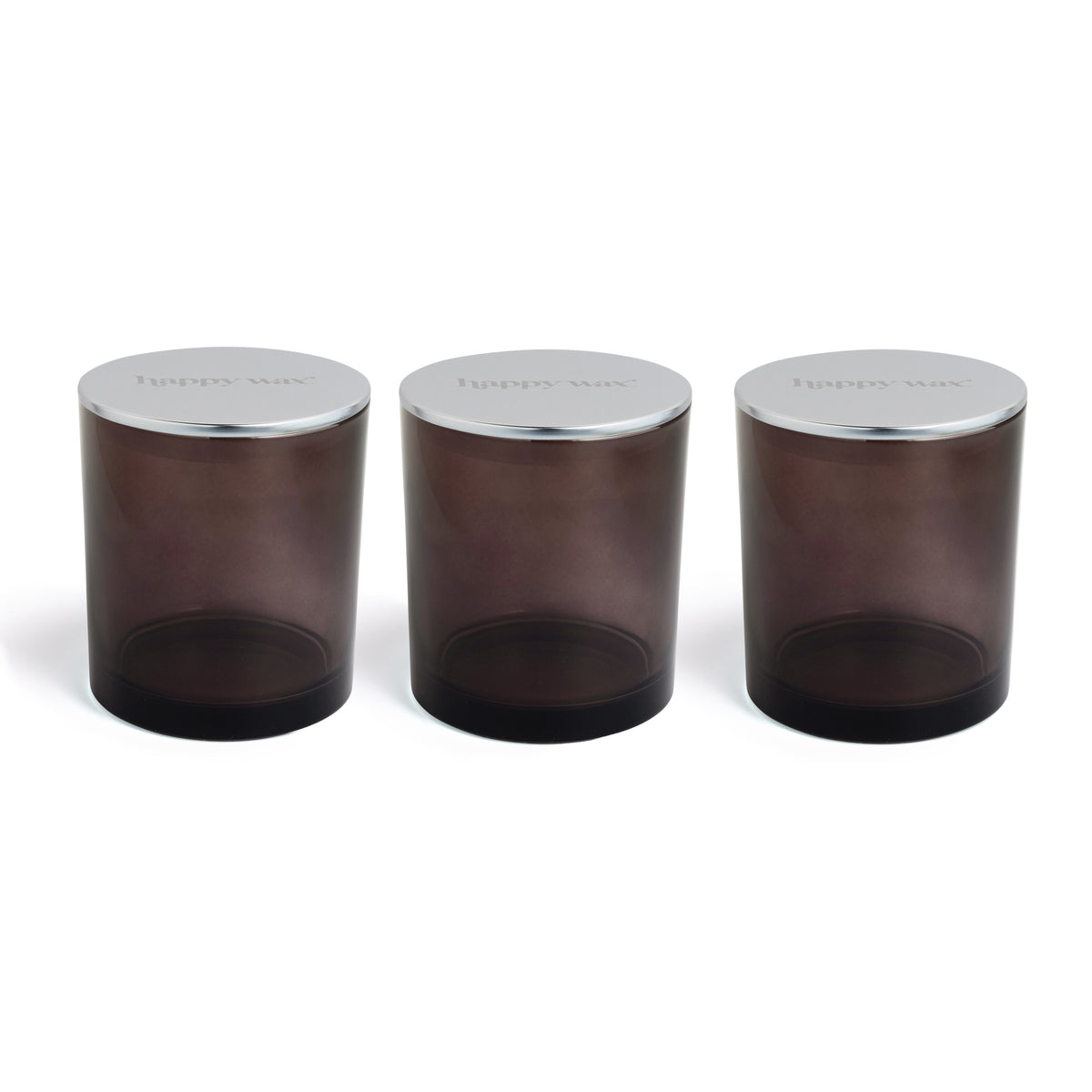 Three dark brown glass wax melt jars with silver metal lids arranged in a row.