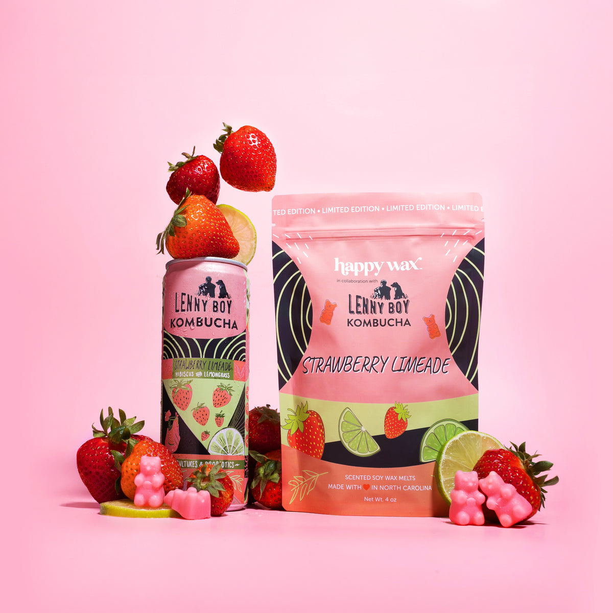 Pink wax melts package with strawberry limeade branding, surrounded by fresh strawberries, lime slices, and pink wax melts on