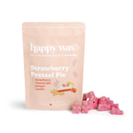 Pink wax melts next to a peach-colored pouch labeled "Strawberry Pretzel Pie" by Happy Wax.