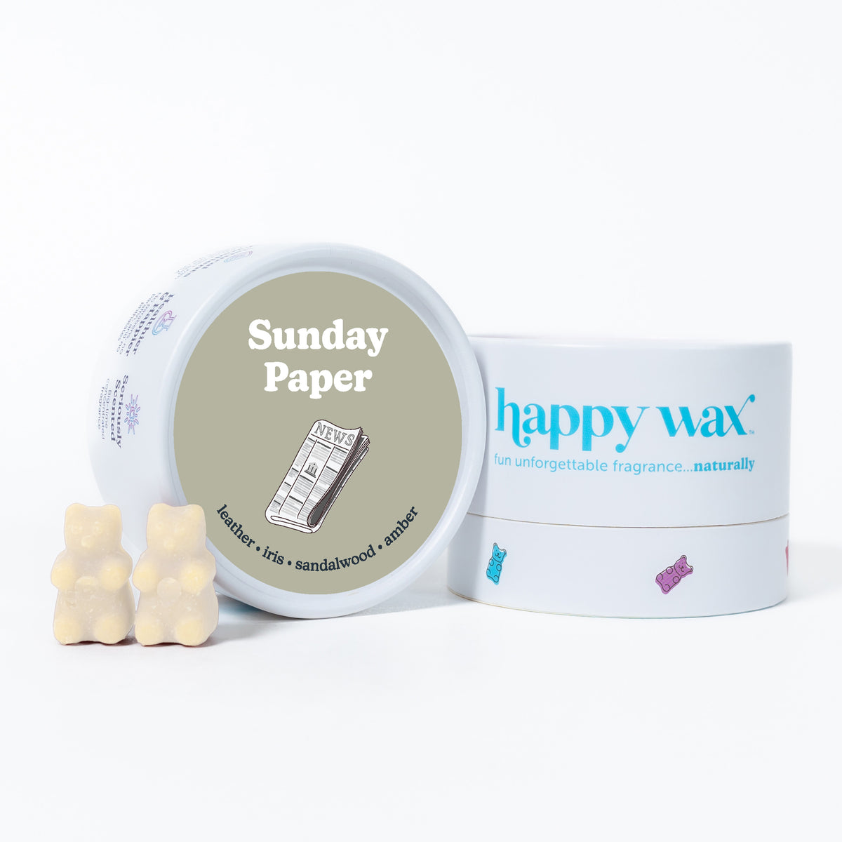 White ceramic container with "Sunday Paper" label and two cream-colored bear-shaped wax melts displayed beside happy wax bran