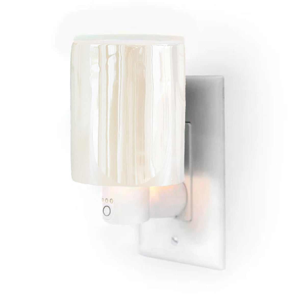Iridescent wax warmer with ribbed glass shade plugged into white outlet timer base.