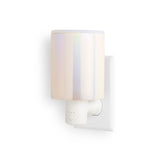 White wall-mounted wax warmer with cylindrical frosted glass top and outlet plug base with timer control button.